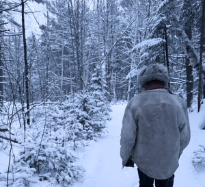Walking a snowy trail through the woods